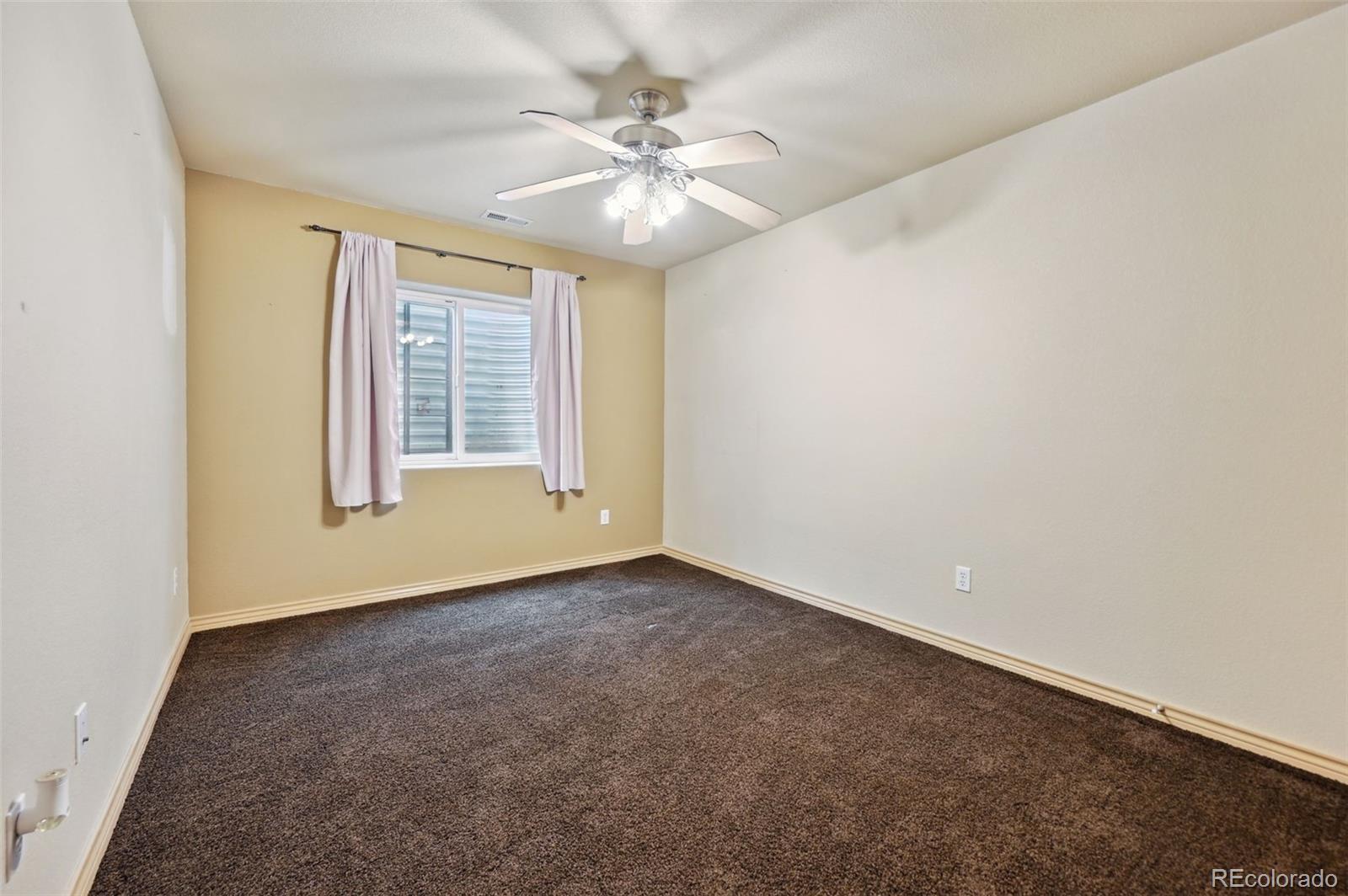 1625 North Yoder Road Yoder, CO 80864 - Photo 32 of 50 an empty room with windows and fan