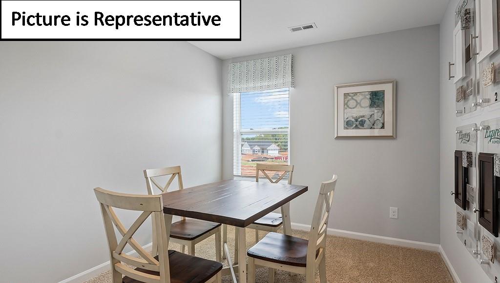 7120 North Mill Road Charlotte, NC 28216 - Photo 23 of 26 a view of a room that has a table and chair in it
