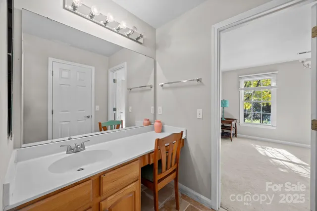 a view of a livingroom with a window and a chandelier