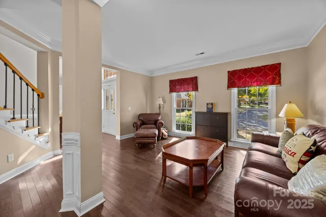 a dining room with furniture potted plants and wooden floor