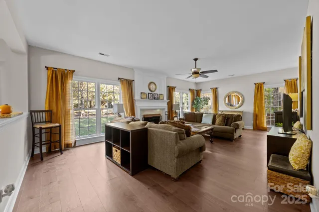 a living room with fireplace furniture and a flat screen tv