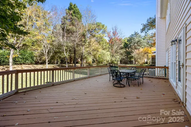 a view of a roof deck with table and chairs and wooden floor