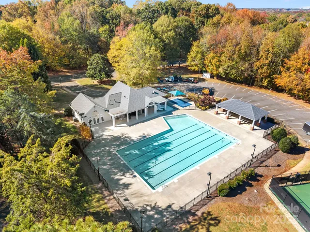 an aerial view of a house with a swimming pool