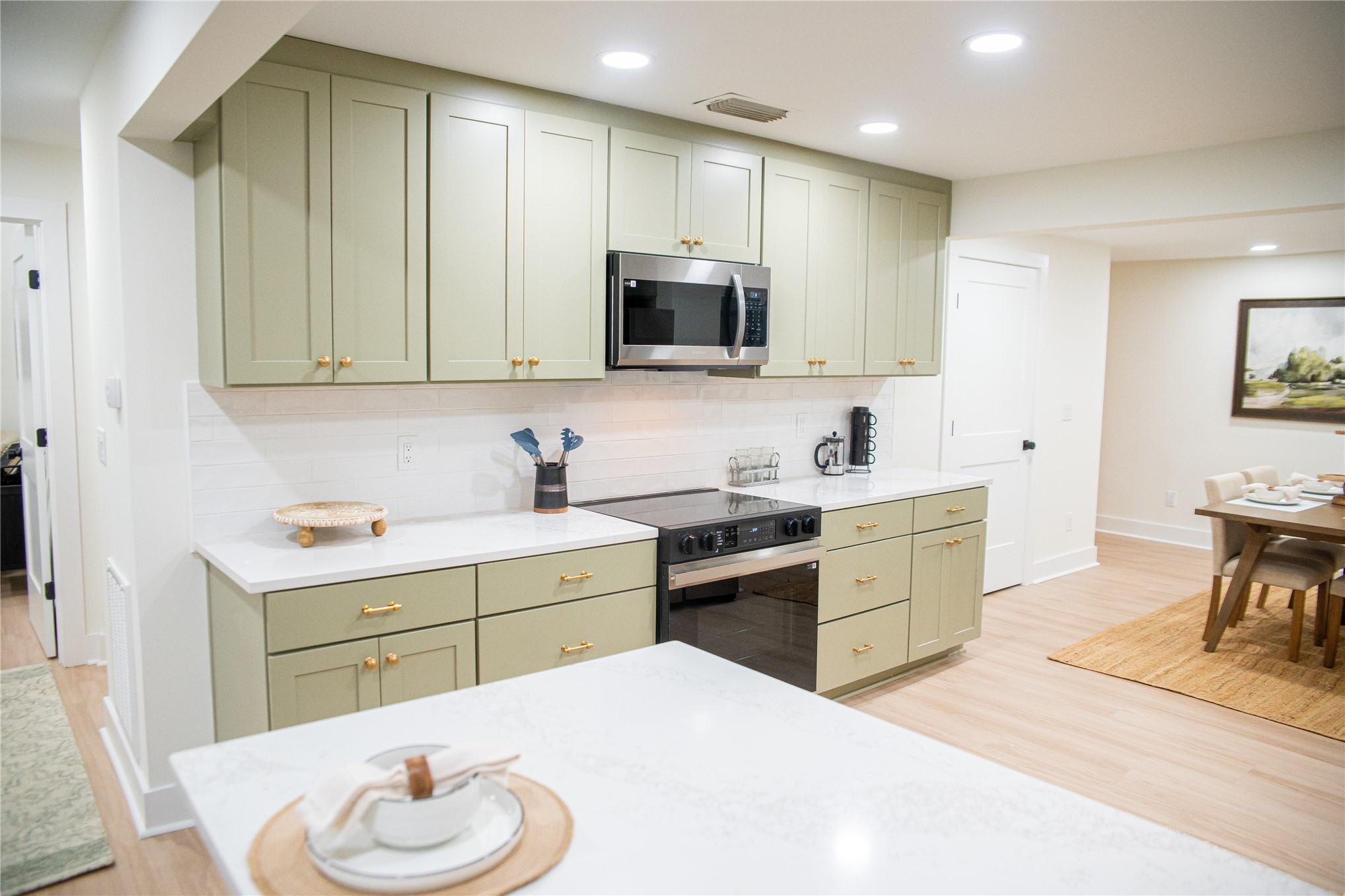 610 Division Street Fernandina Beach, FL 32034 - Photo 15 of 43 a kitchen with a sink stove top oven and microwave