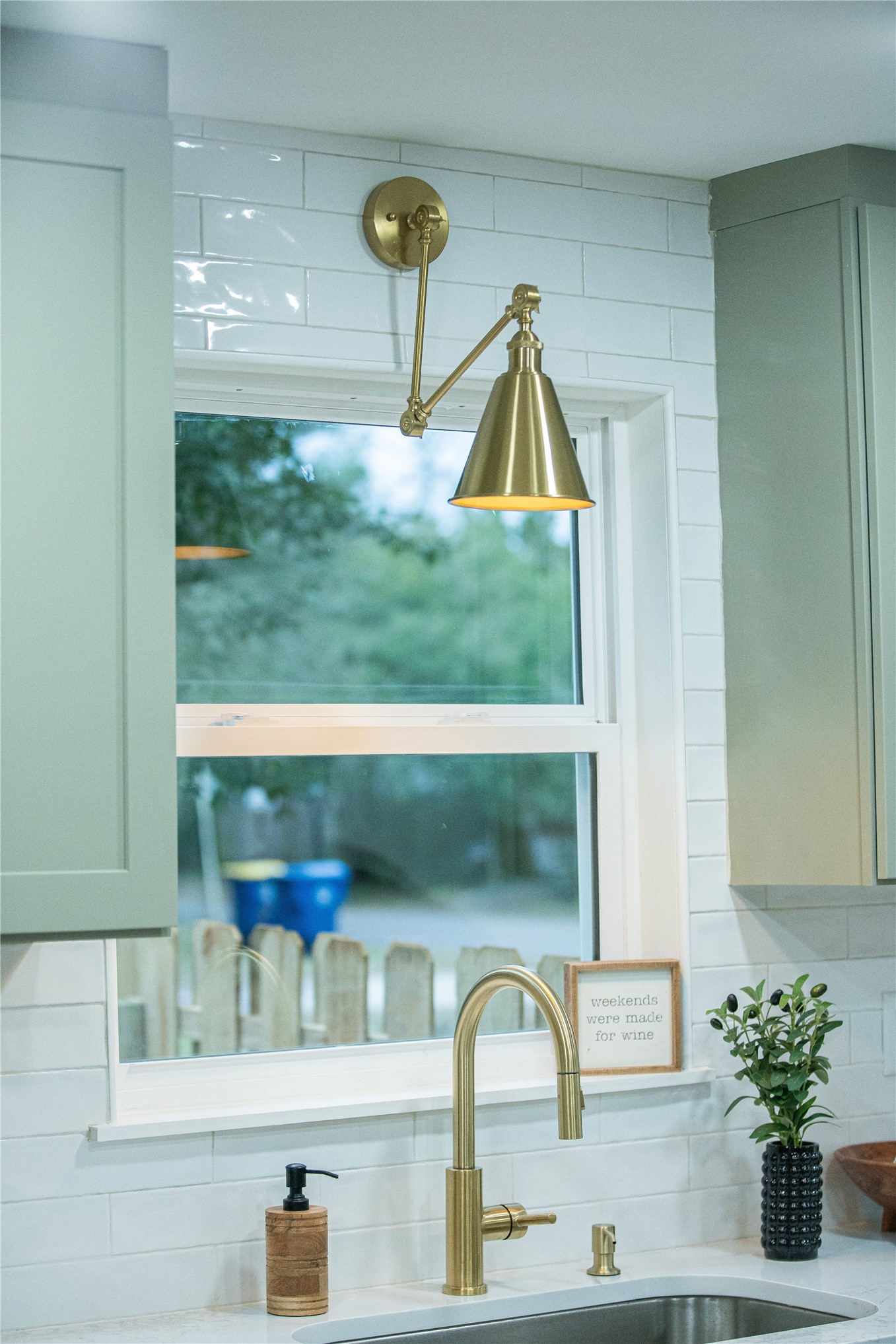 610 Division Street Fernandina Beach, FL 32034 - Photo 16 of 43 a bathroom with a sink a mirror and potted plant