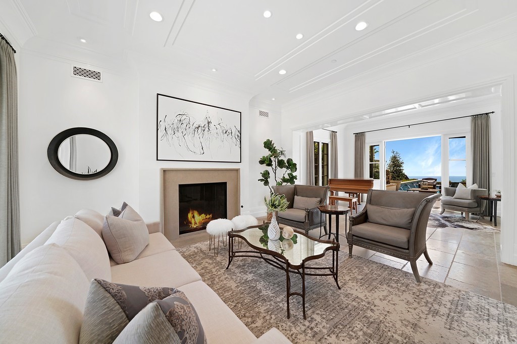 9 Offshore Newport Coast, CA 92657 - Photo 21 of 75 a living room with furniture a fireplace and a flat screen tv