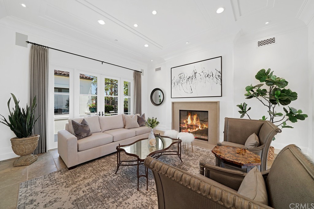 9 Offshore Newport Coast, CA 92657 - Photo 22 of 75 a living room with furniture a fireplace and a large mirror