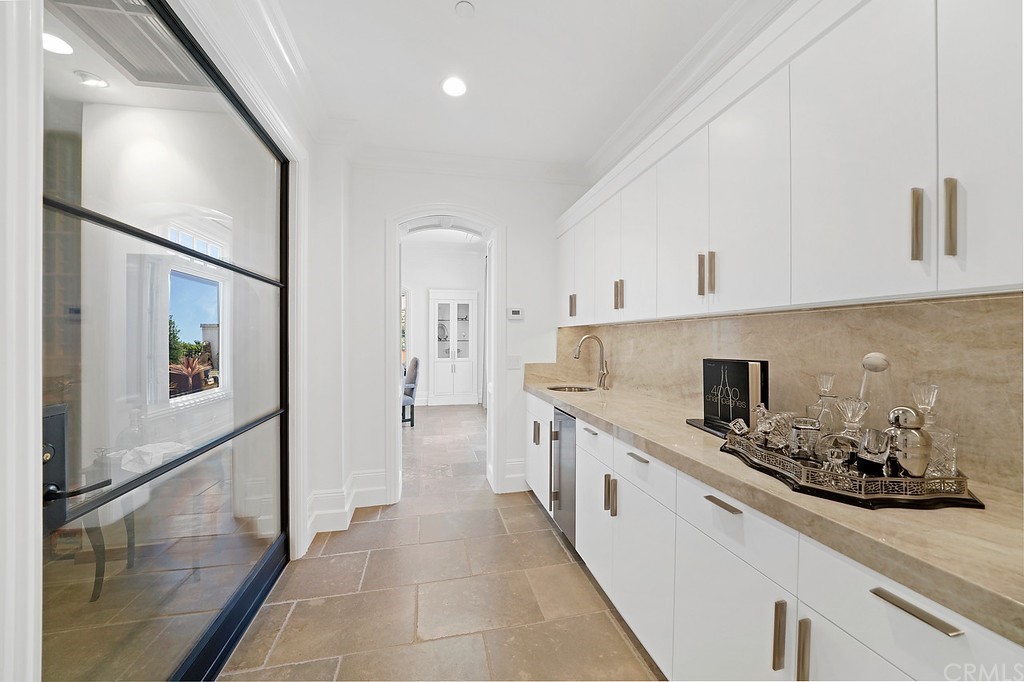 9 Offshore Newport Coast, CA 92657 - Photo 30 of 75 a large white kitchen with stainless steel appliances a stove a sink and a refrigerator