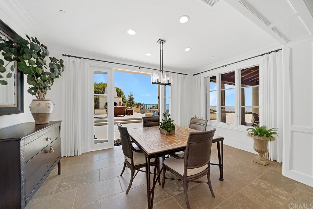 9 Offshore Newport Coast, CA 92657 - Photo 32 of 75 a kitchen with a table and chairs in it