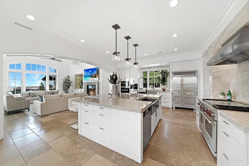 9 Offshore Newport Coast, CA 92657 - Photo 35 of 75 a kitchen with stainless steel appliances kitchen island granite countertop a sink and cabinets