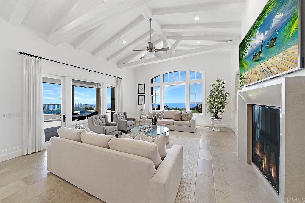9 Offshore Newport Coast, CA 92657 - Photo 37 of 75 a living room with furniture and a fireplace