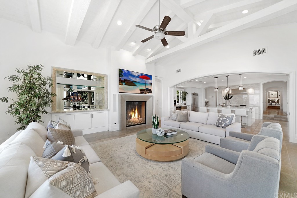 9 Offshore Newport Coast, CA 92657 - Photo 39 of 75 a living room with furniture a fireplace and a flat screen tv