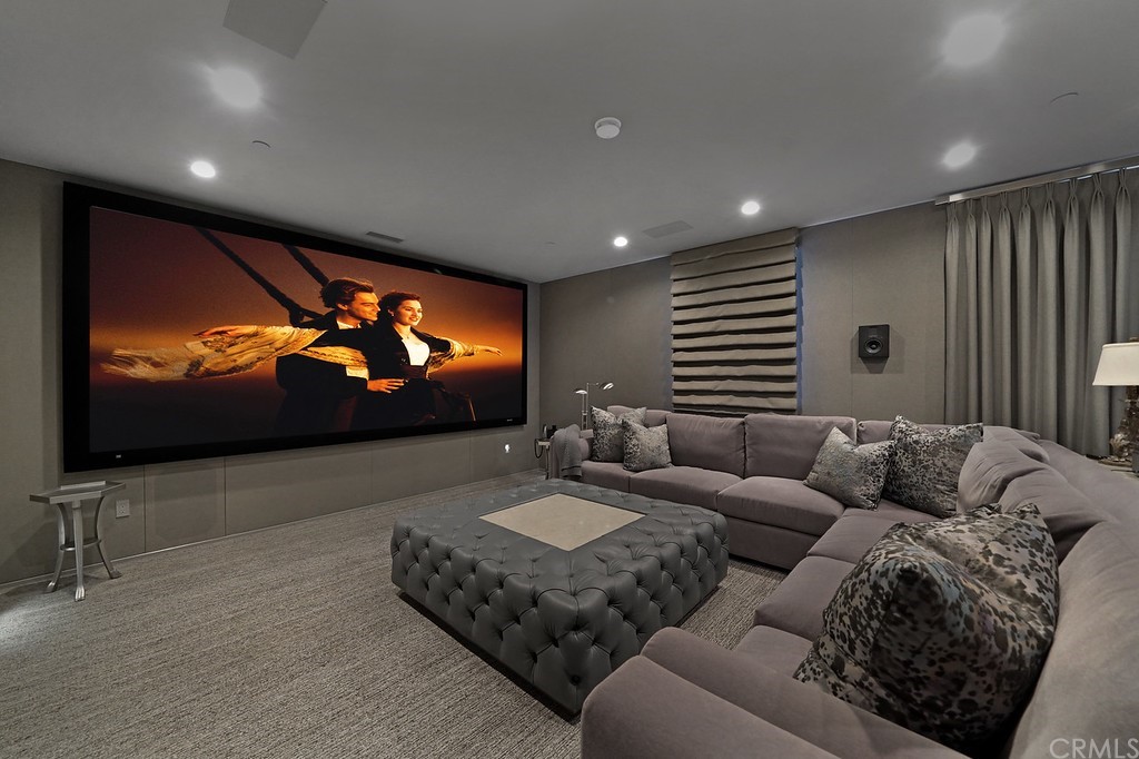 9 Offshore Newport Coast, CA 92657 - Photo 41 of 75 a living room with furniture and a projector screen