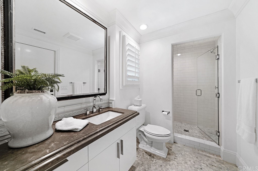 9 Offshore Newport Coast, CA 92657 - Photo 43 of 75 a bathroom with a granite countertop sink toilet a large mirror a vanity and shower