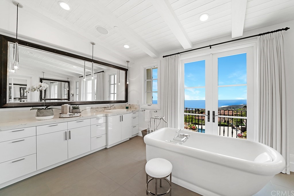 9 Offshore Newport Coast, CA 92657 - Photo 49 of 75 a bathroom with a granite countertop sink mirror bathtub and toilet