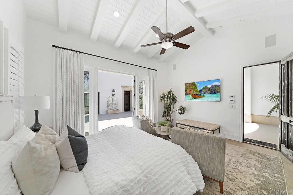 9 Offshore Newport Coast, CA 92657 - Photo 55 of 75 a bedroom with a bed and a chandelier