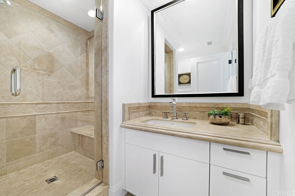 9 Offshore Newport Coast, CA 92657 - Photo 56 of 75 a bathroom with a shower sink and mirror