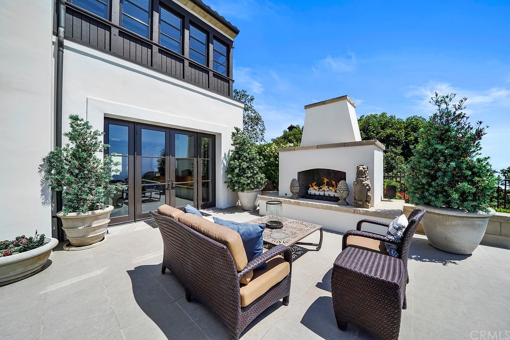 9 Offshore Newport Coast, CA 92657 - Photo 58 of 75 a outdoor space with patio furniture and a fireplace