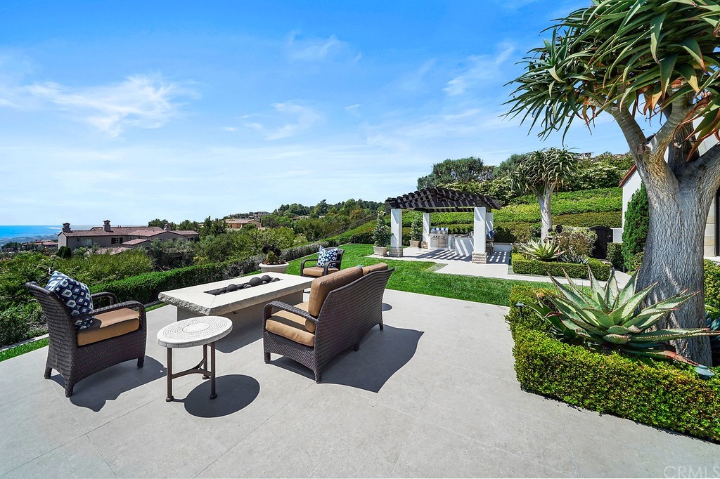 9 Offshore Newport Coast, CA 92657 - Photo 60 of 75 a view of a patio with couches fire pit and a big yard