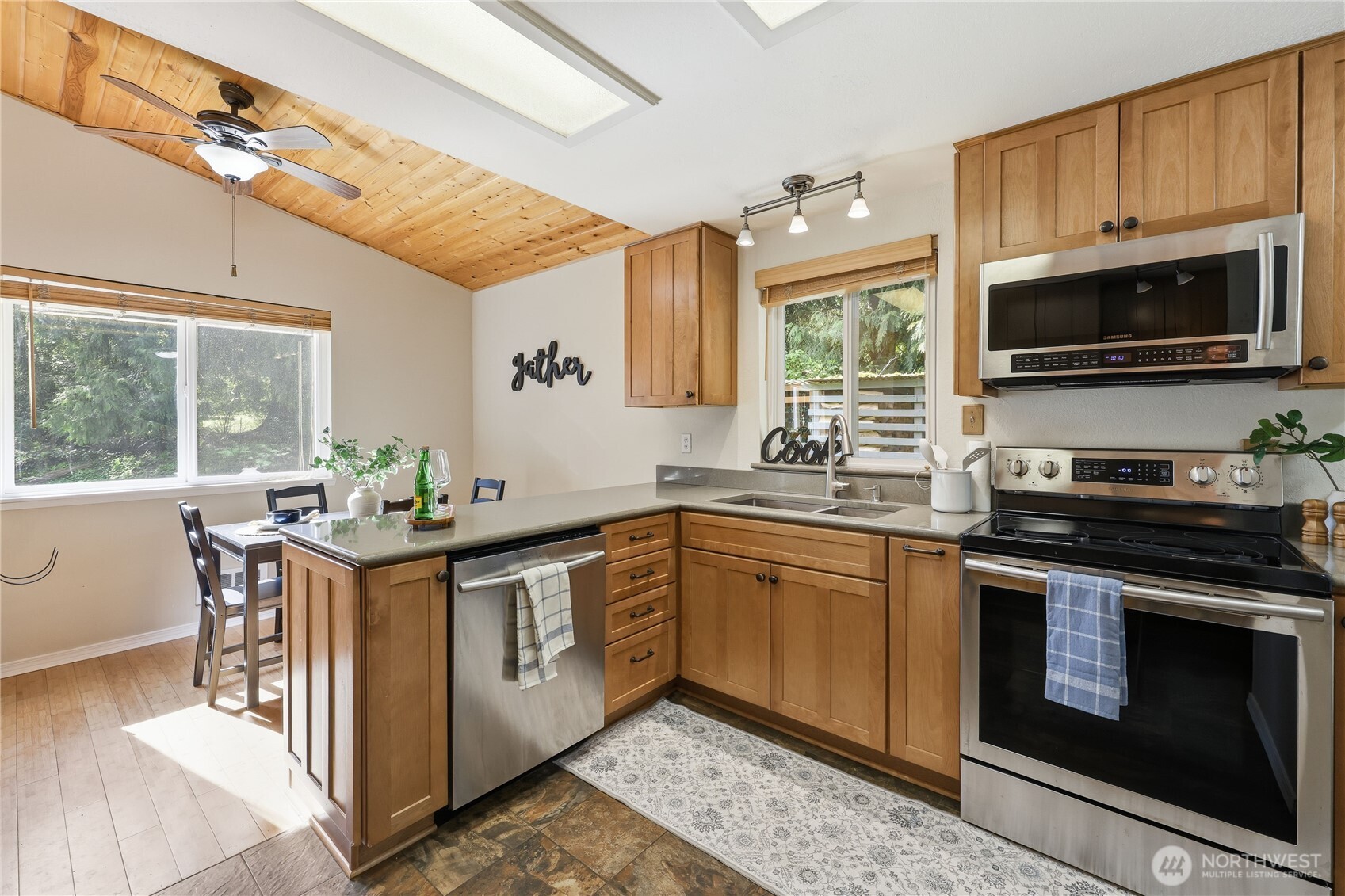 70 Salal Way Sequim, WA 98382 - Photo 15 of 36 a kitchen with stainless steel appliances a stove a sink and a microwave
