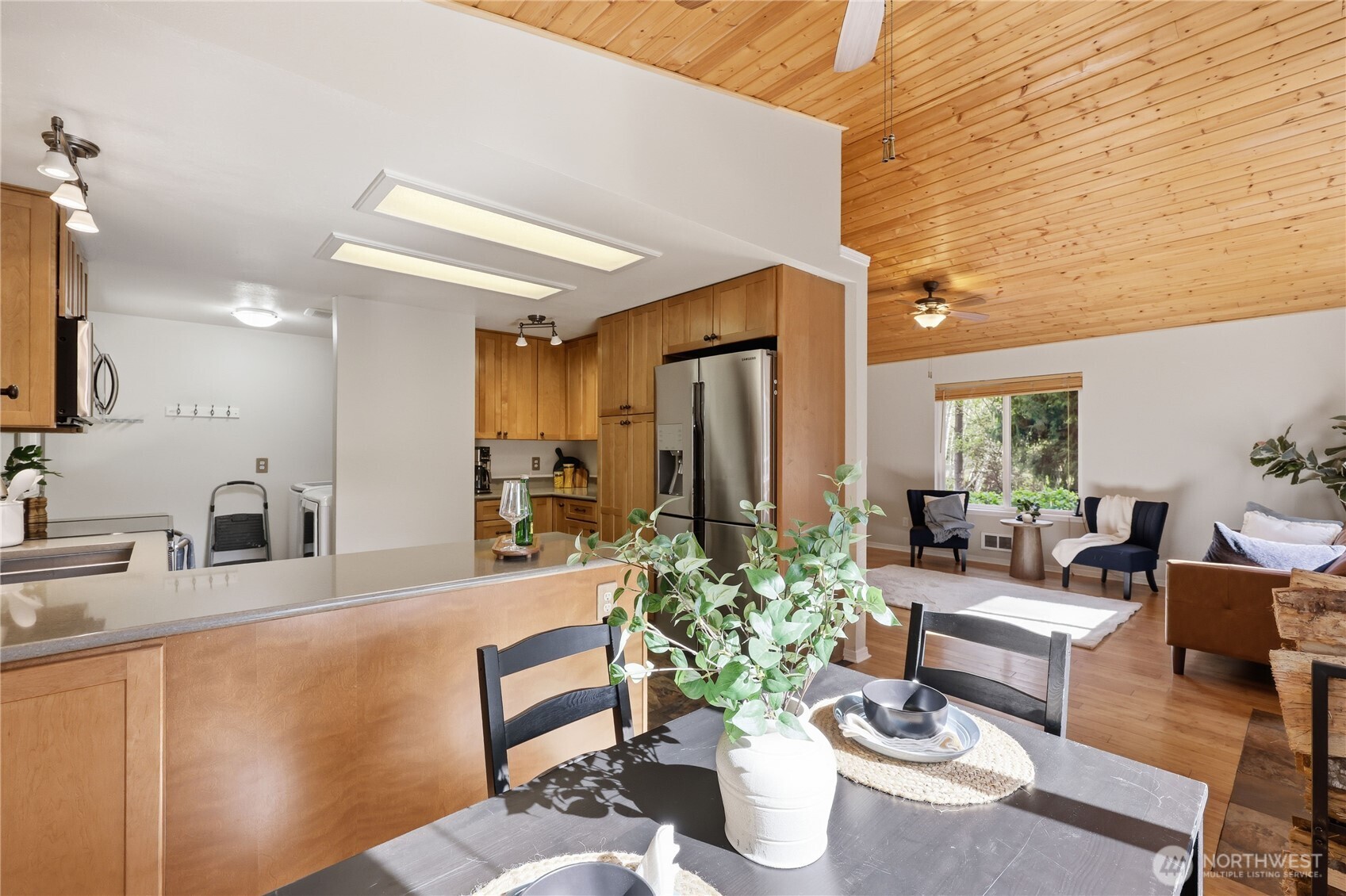 70 Salal Way Sequim, WA 98382 - Photo 16 of 36 a living room with furniture kitchen view and a potted plant