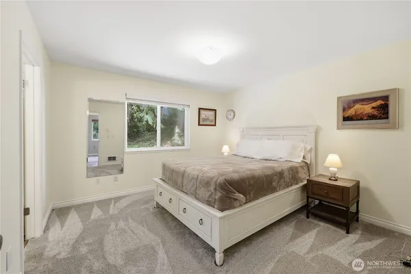 a spacious bedroom with a bed and window