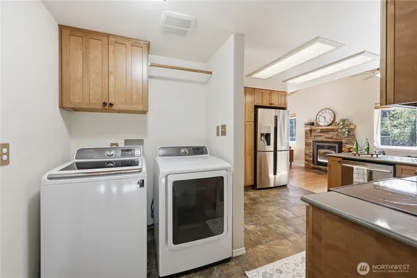 a kitchen with a stove top oven and refrigerator