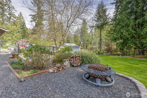 a view of a backyard with table and chairs