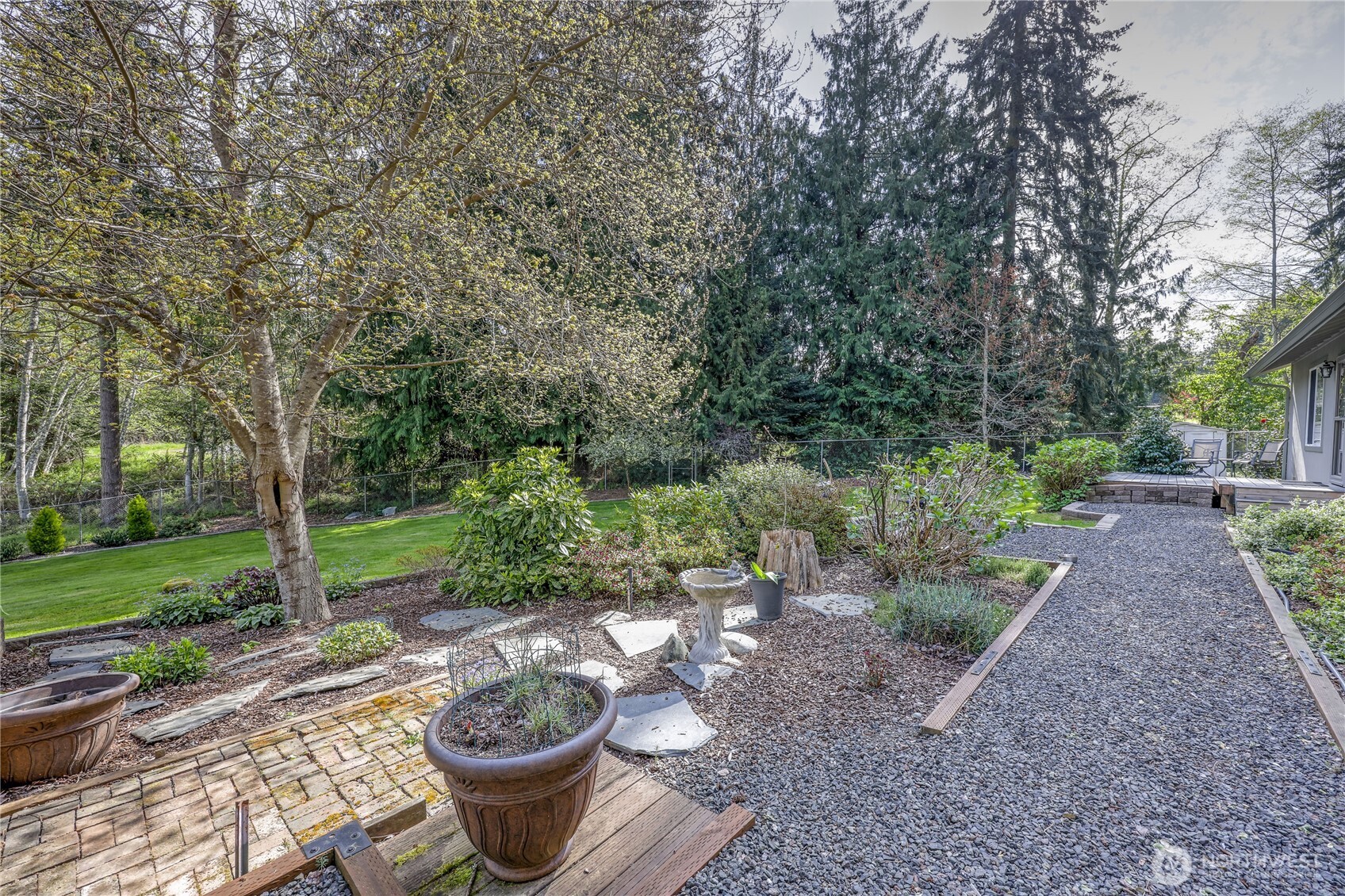 70 Salal Way Sequim, WA 98382 - Photo 30 of 36 a view of a backyard with table and chairs plants and trees