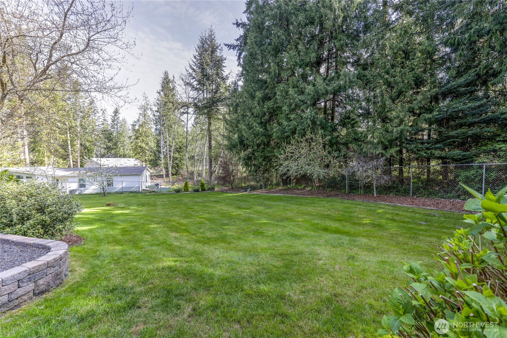 70 Salal Way Sequim, WA 98382 - Photo 31 of 36 a backyard of a house with lots of green space
