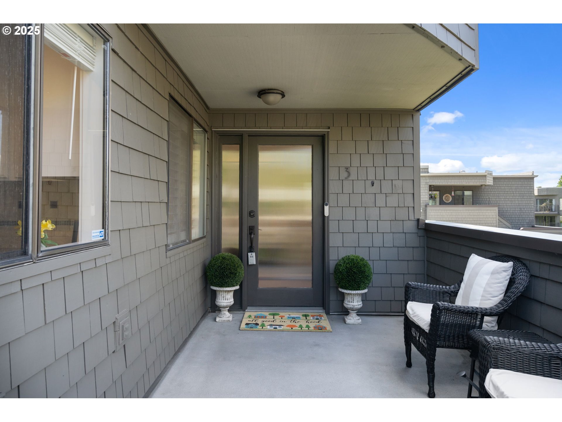 a balcony with table and chairs