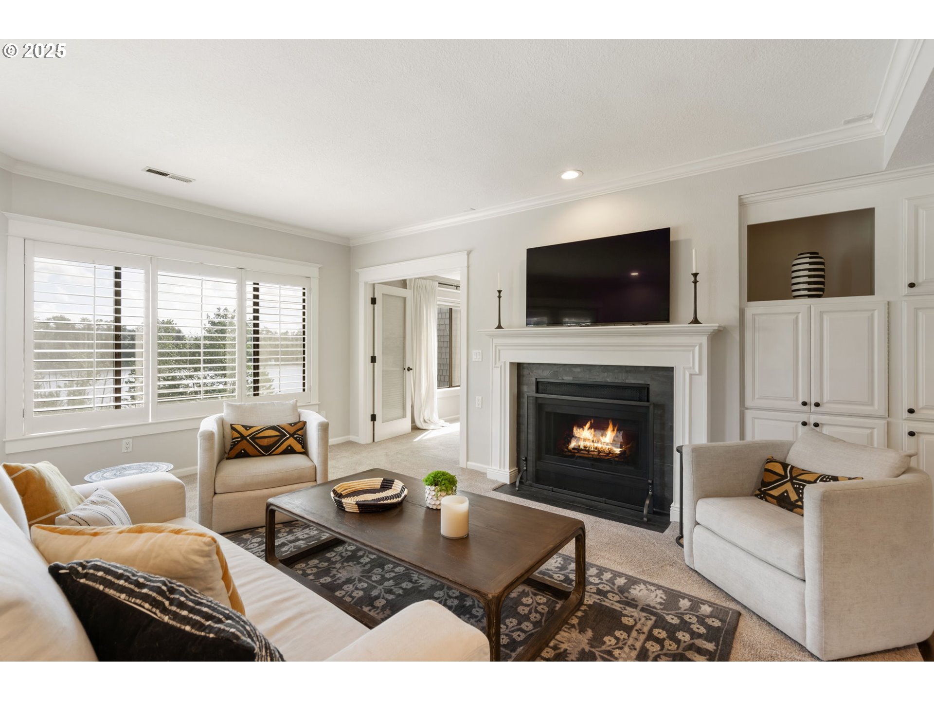 5620 South Riverside Lane, Unit 3 Portland, OR 97239 - Photo 17 of 41 a living room with furniture a flat screen tv and a fireplace