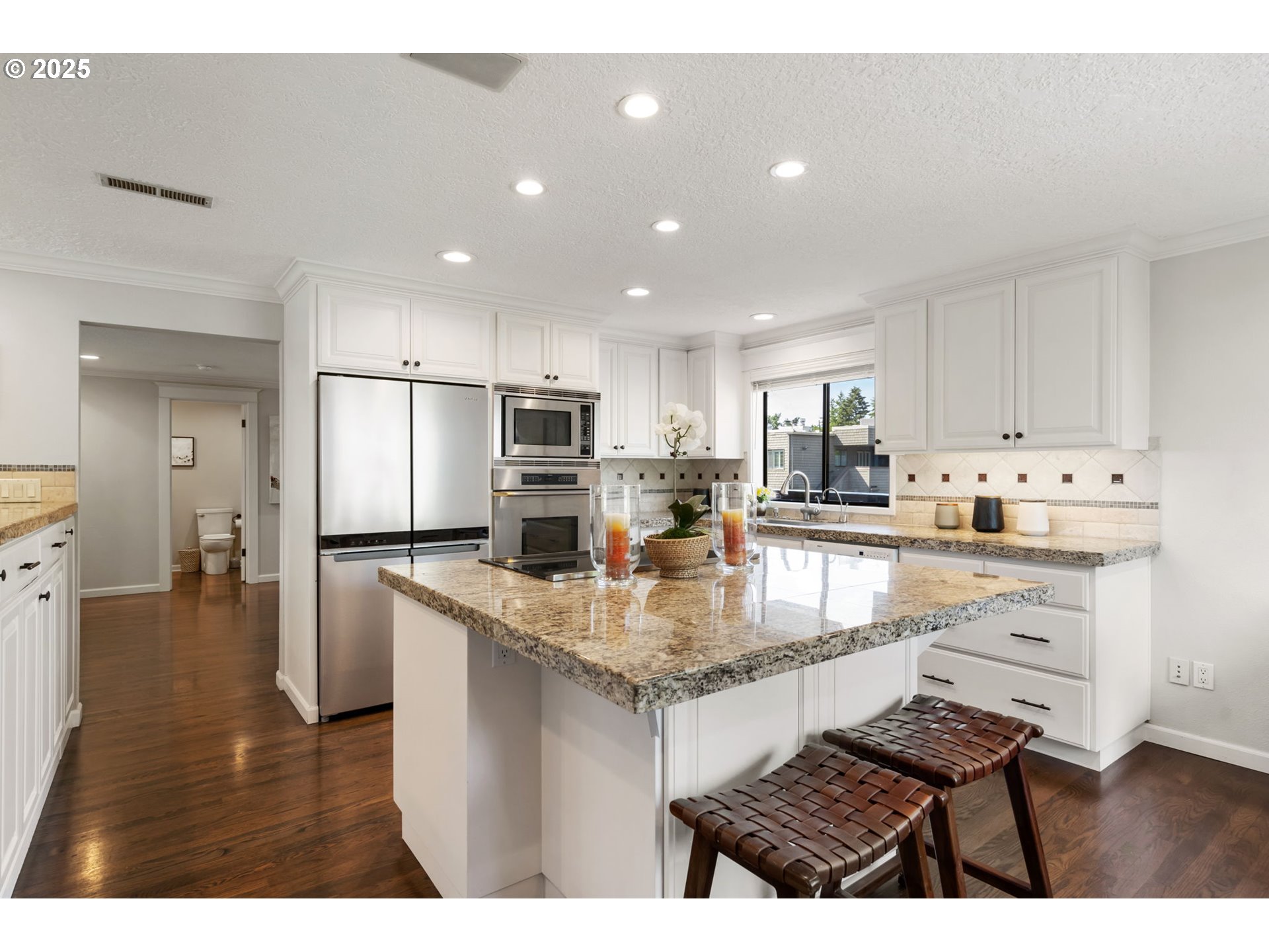 5620 South Riverside Lane, Unit 3 Portland, OR 97239 - Photo 23 of 41 a kitchen with stainless steel appliances granite countertop a sink refrigerator and cabinets