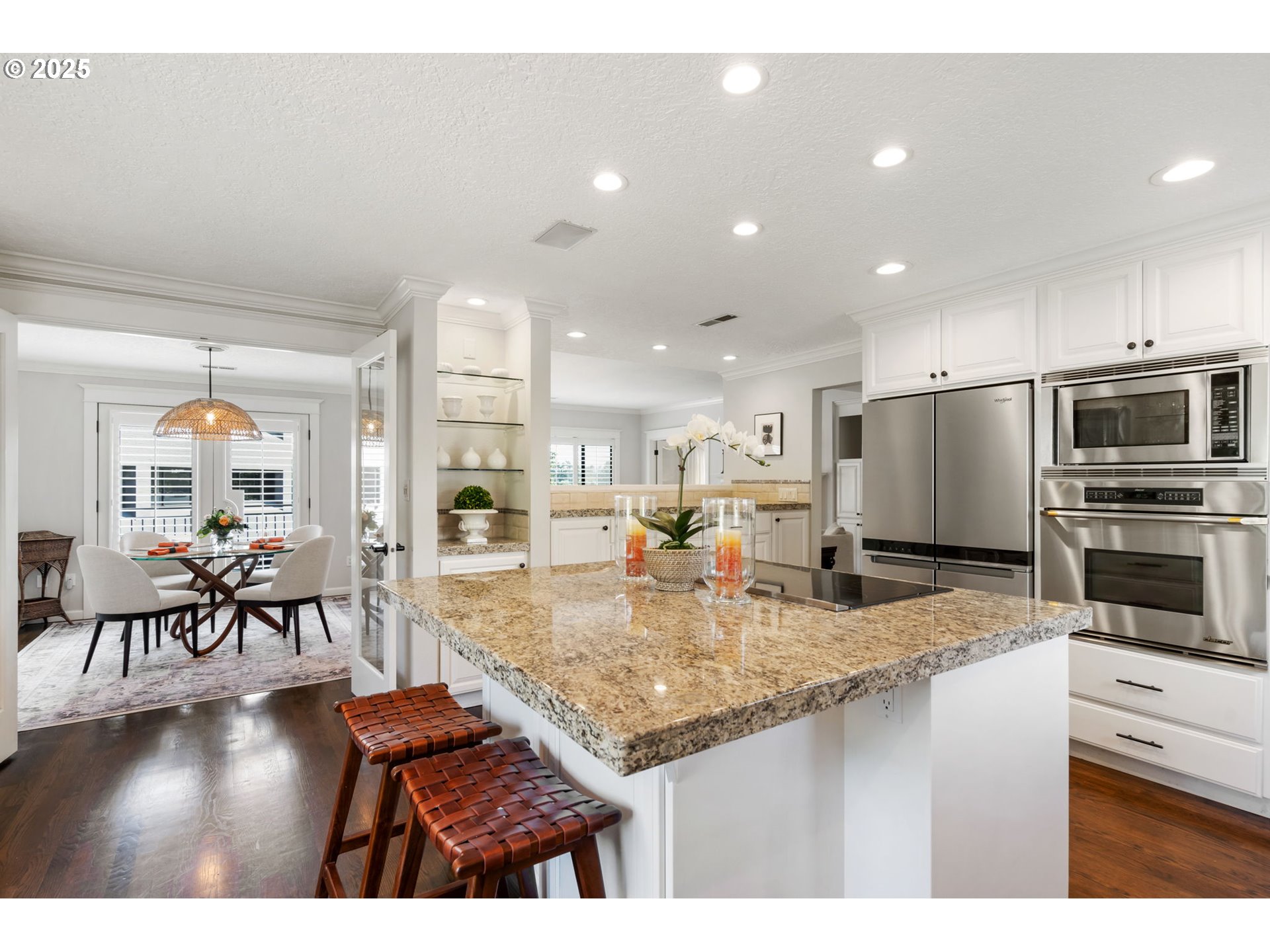 5620 South Riverside Lane, Unit 3 Portland, OR 97239 - Photo 28 of 41 a kitchen with stainless steel appliances granite countertop a stove top oven a sink a dining table and chairs