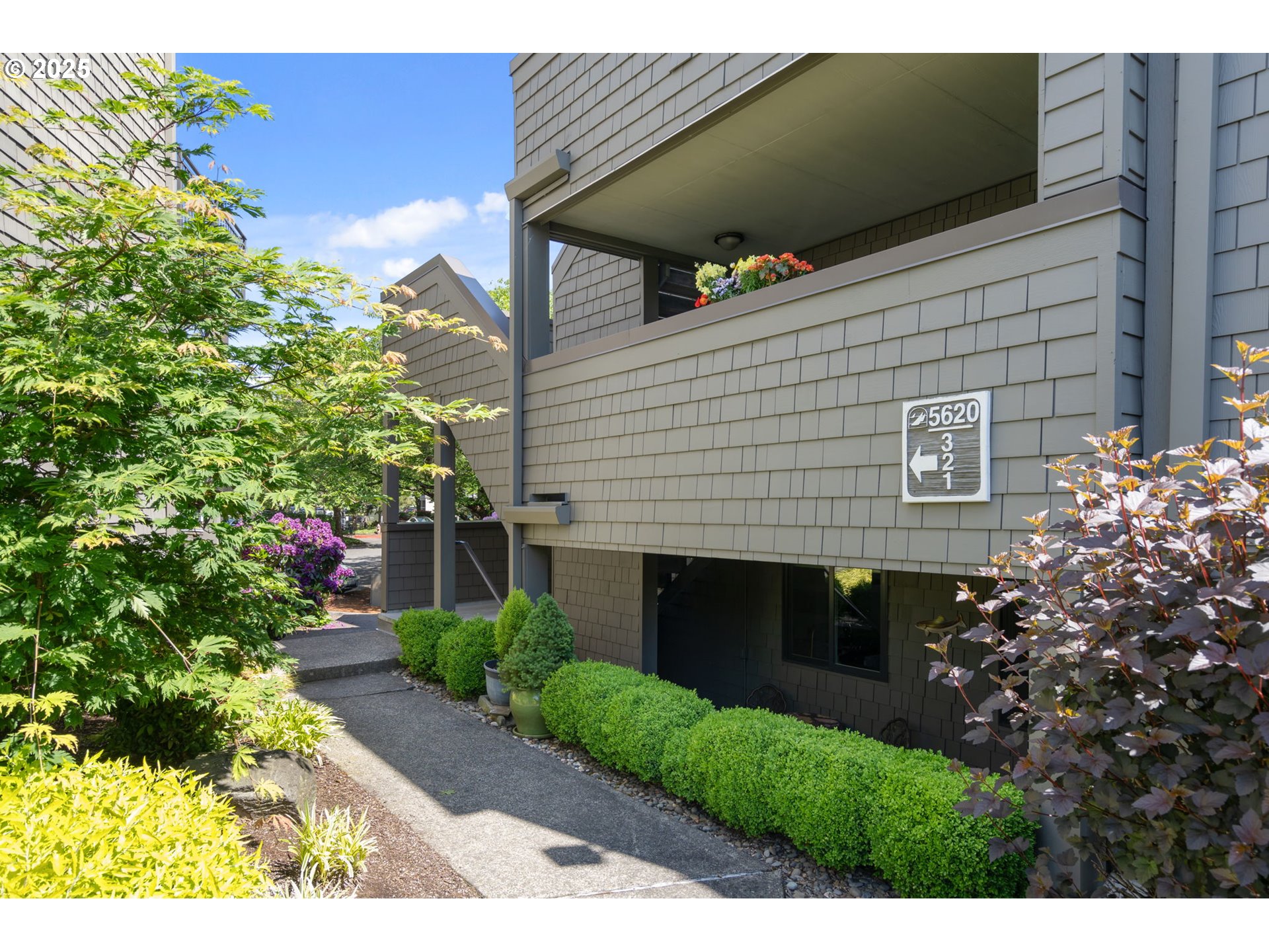 5620 South Riverside Lane, Unit 3 Portland, OR 97239 - Photo 3 of 41 a front view of a house with a yard