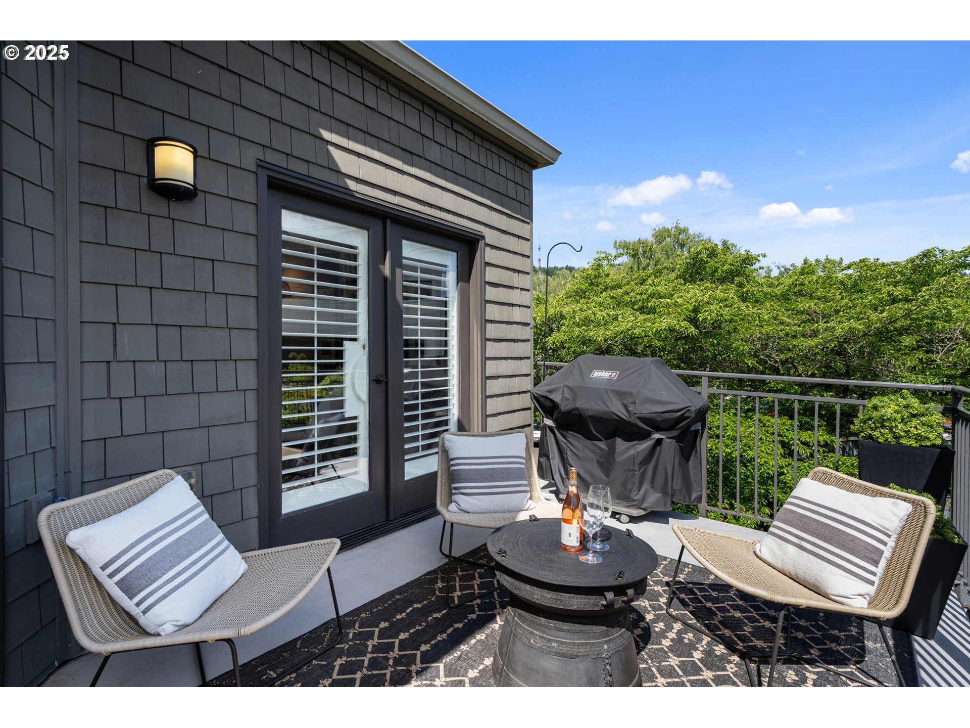 5620 South Riverside Lane, Unit 3 Portland, OR 97239 - Photo 31 of 41 a view of a patio with a dining table and chairs with wooden floor