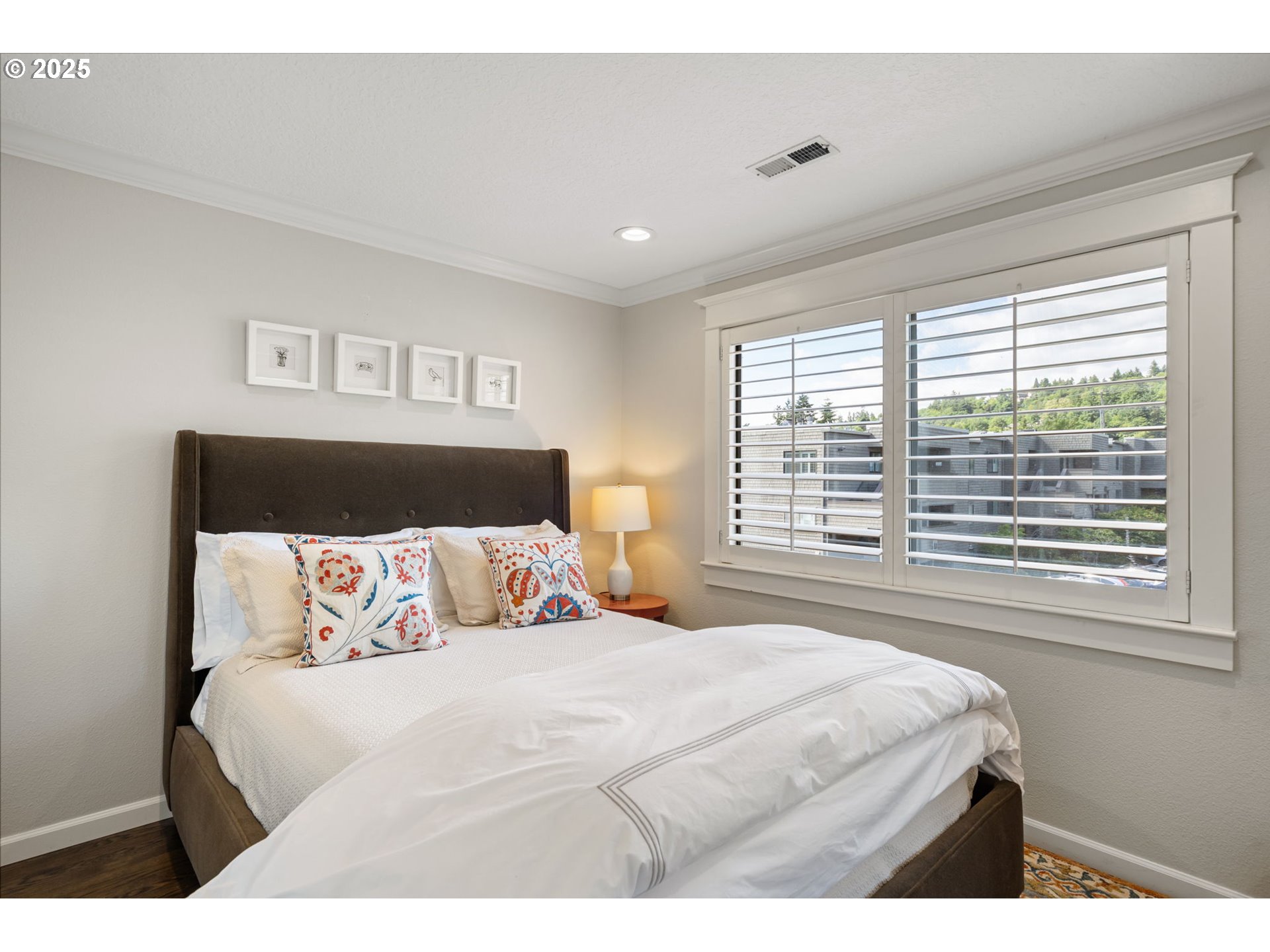 5620 South Riverside Lane, Unit 3 Portland, OR 97239 - Photo 8 of 41 a bedroom with a large bed and a large window