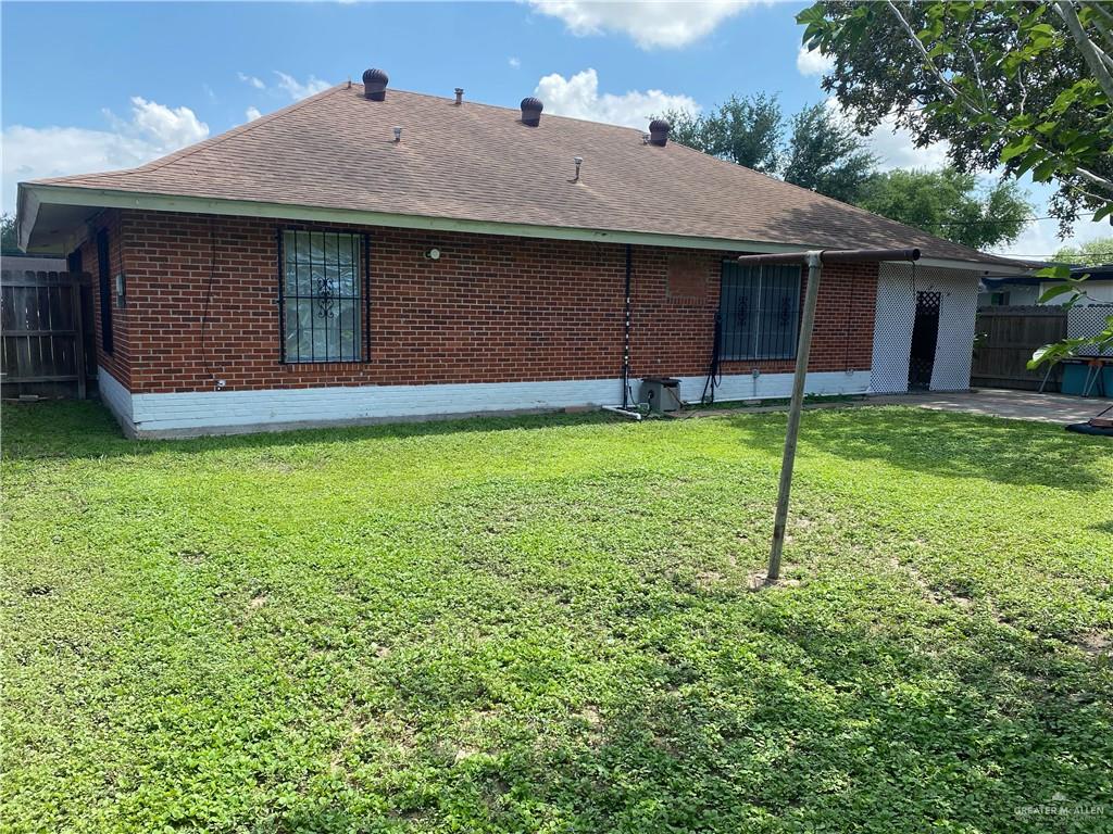616 5th Street Weslaco, TX 78596 - Photo 6 of 6 a backyard of a house with childrens swings and slides