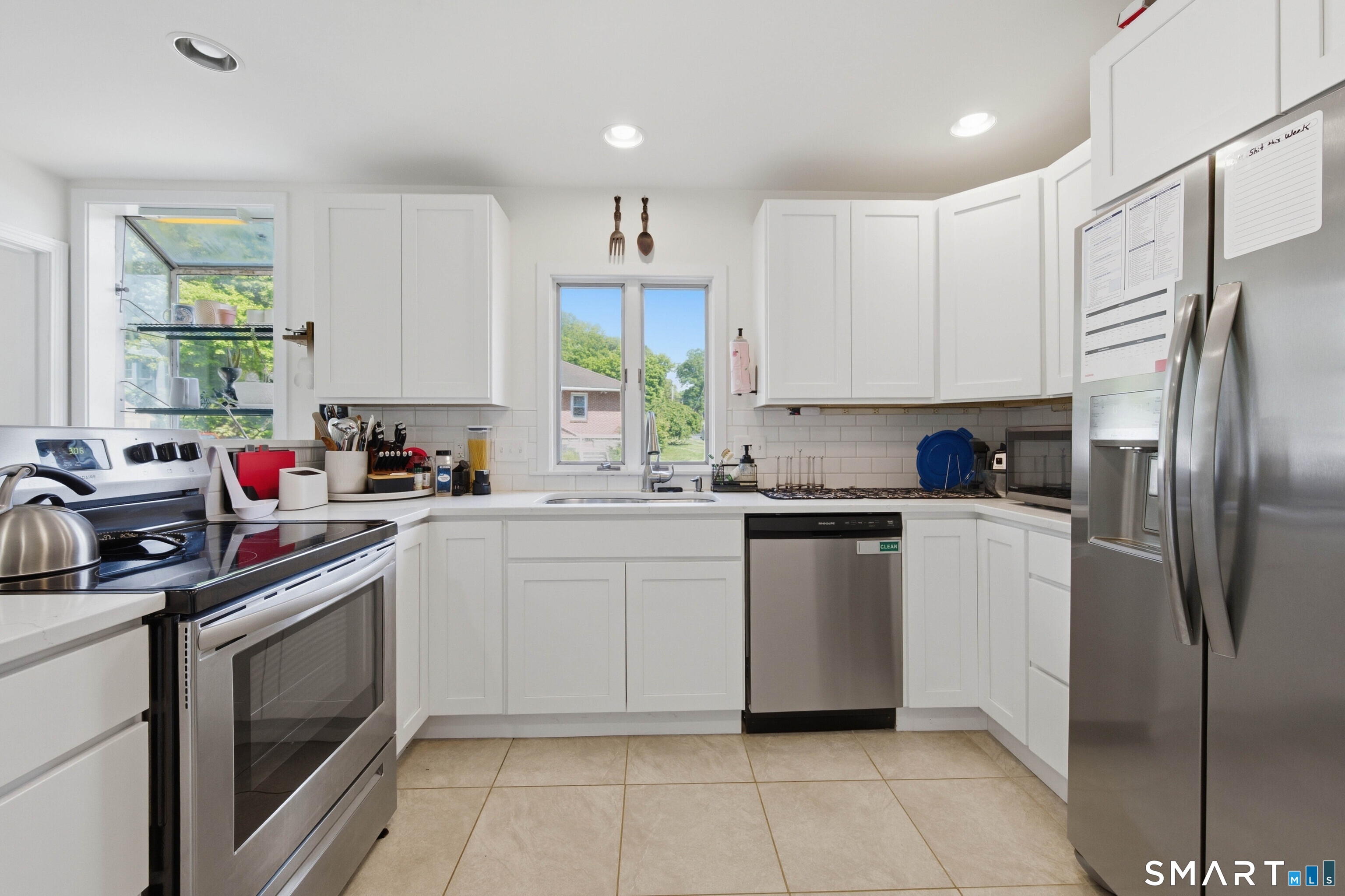 120 May Street Naugatuck, CT 06770 - Photo 3 of 31 a kitchen with a white cabinets and white appliances