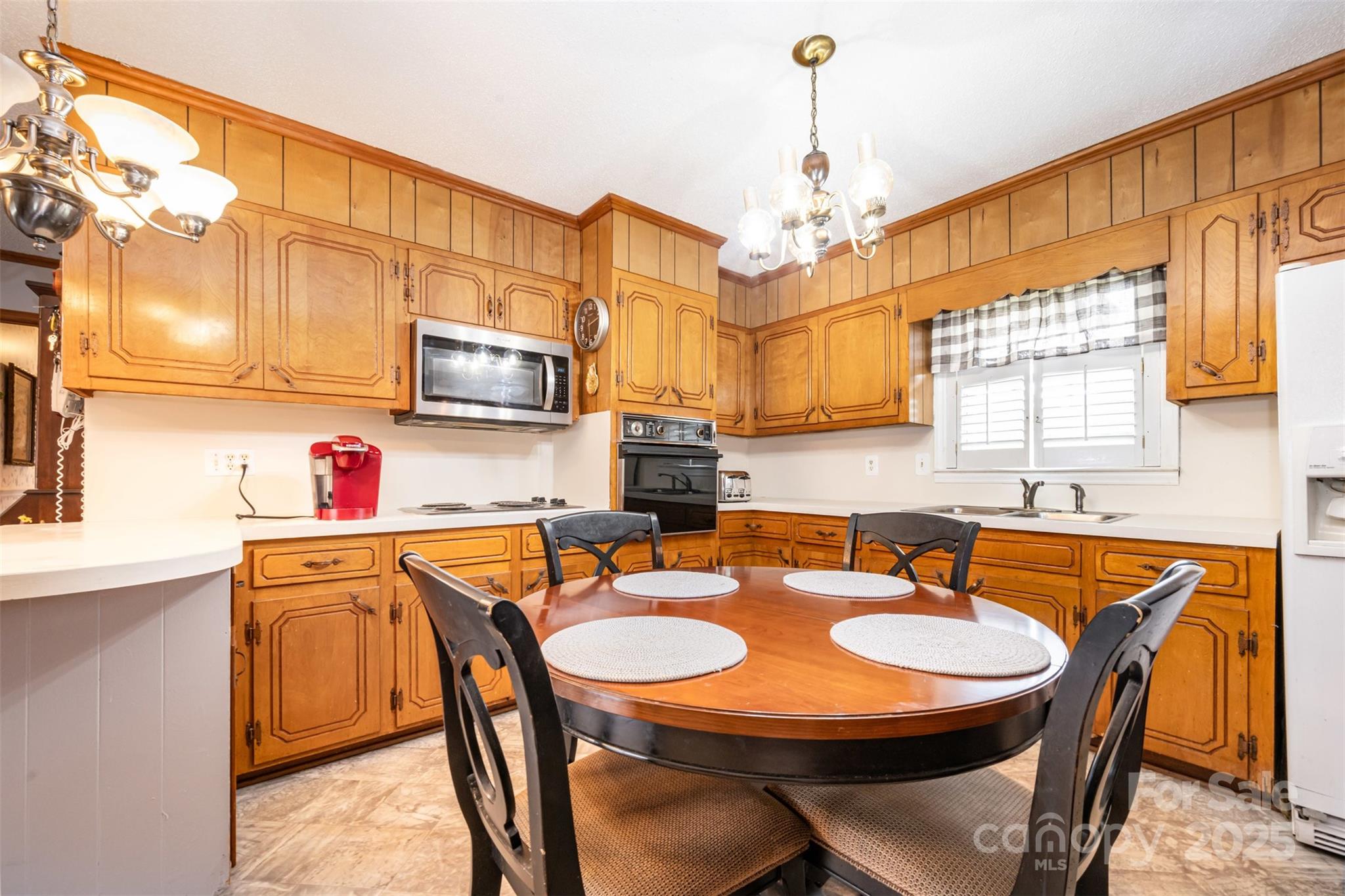 2236 Old Hickory Grove Road Mount Holly, NC 28120 - Photo 6 of 27 a kitchen that has a table chairs in it and wooden floors