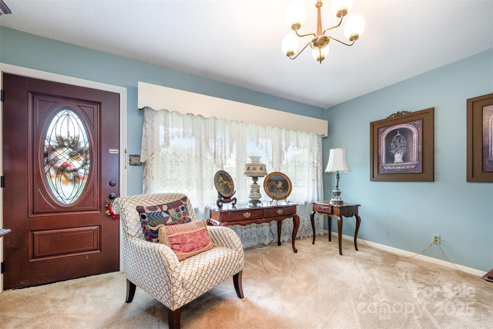 2236 Old Hickory Grove Road Mount Holly, NC 28120 - Photo 10 of 27 a living room with furniture a chandelier and a window