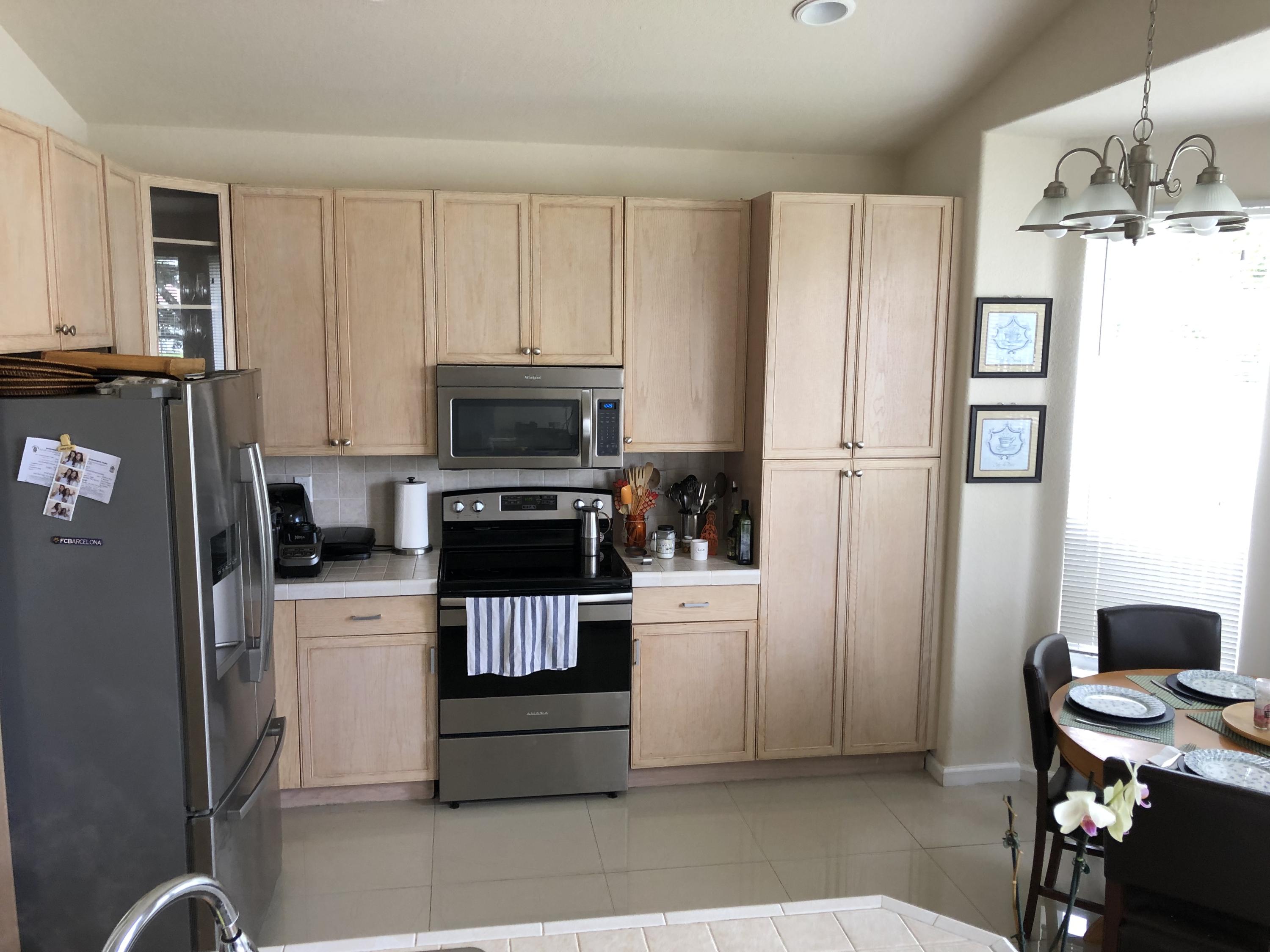 18805 Southwest 29th Street Miramar, FL 33029 - Photo 4 of 8 a kitchen with stainless steel appliances a refrigerator stove and microwave