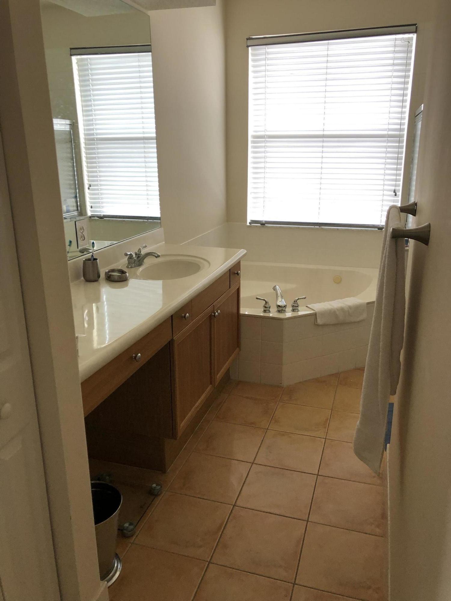 18805 Southwest 29th Street Miramar, FL 33029 - Photo 7 of 8 a bathroom with a tub sink and mirror