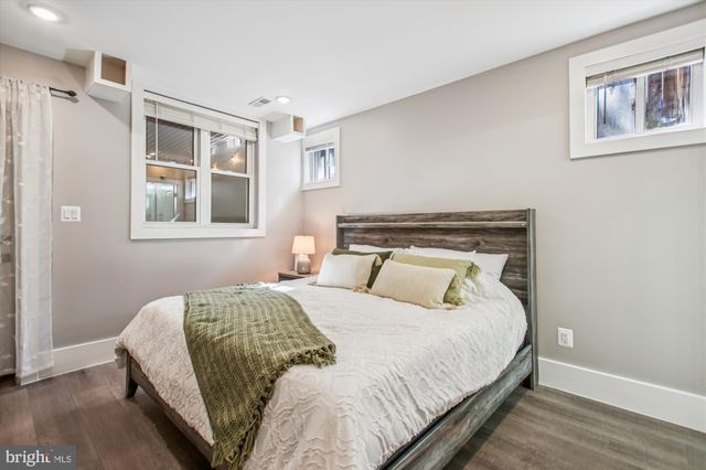 a bedroom with a bed and a night stand