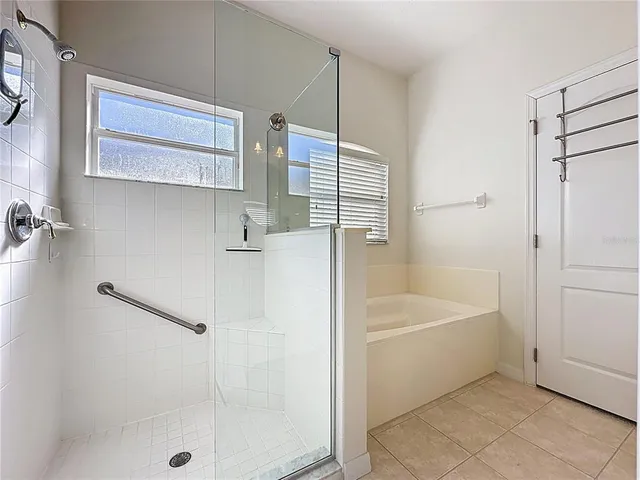 a bed room with a bed and a ceiling fan