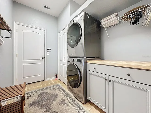 a dining room with furniture a chandelier and wooden floor