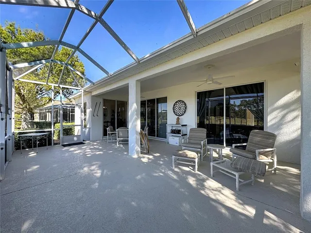a view of a house with swimming pool and sitting area
