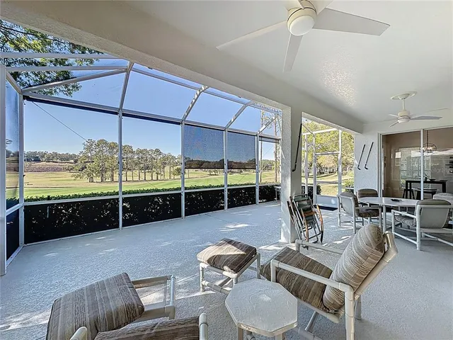 a kitchen with a table chairs refrigerator and cabinets