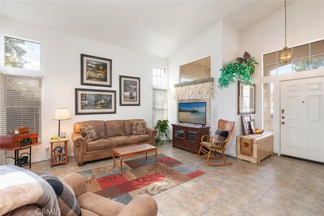 a living room with furniture kitchen view and a fireplace