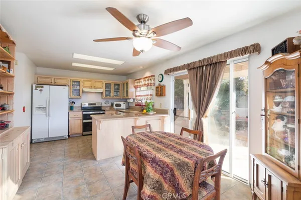 a kitchen with a refrigerator a stove top oven a sink and a large window